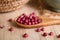 Purple coriander seeds in wooden spoon