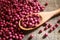 Purple coriander seeds in wooden spoon