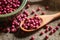 Purple coriander seeds in wooden spoon