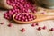 Purple coriander seeds in wooden spoon