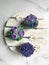 Purple cupcakes decorated with floral theme