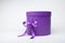 Purple cylindrical gift box on white background