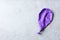 Purple deflated balloon on grey background