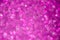 Purple defocused glitter lights background. Rounded defocused lights