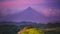 Purple dense clouds surround Mayon Volcano silhouette