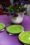 Purple dining table with green plates.