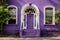 purple door of a colonial revival house with a semi-circular fanlight above