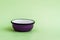 Purple Enamel Bowl on Green Background