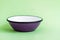 Purple Enamel Bowl on Green Background