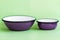 Purple Enamel Bowls on Green Background