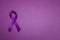 Purple epilepsy awareness ribbon on a purple background with copy space. World epilepsy day