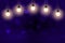 purple fantastic brilliant glitter lights defocused bokeh abstract background with light bulbs and falling snow flakes fly,