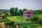Purple farmhouse in the middle of fields in the Albanian countryside. Luxurious two-story mansion against the backdrop of bright
