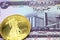 A purple fifty dinar note from Iraq with a gold coin in macro