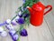 Purple flowers with a red kettle