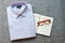 Purple folded men cotton shirt, red glasses and notebook