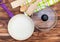 Purple frying pan with glass lid, kitchen wooden utensil and towel on the wooden table. Top view. Cooking meal