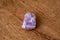 Purple gemstone gem jewel mineral precious stone on wooden underground