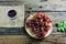 Purple grapes plate, Red wine glass, placed on the old wooden table.