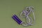Purple Handle Purple and White Jump Rope on Green Background