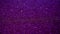 Purple Holiday abstract glitter background with blinking lights.