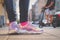 Purple holographic sneakers on a girl legs, with electric scooter in the background, selective focus