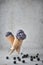 Purple ice cream in glass with blueberry spread on ground on concreat background