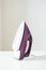 Purple iron on white ironing board