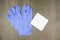 Purple latex gloves and cotton bud on tissue paper