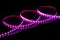 Purple LED strip tape on black background