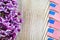 Purple lilac and miniature flags focused on wooden board with room for copy