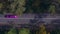 Purple limousine driving fast along the forest road. colored long car, highway