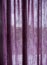 Purple linen single panel curtain hanging on the rail.