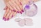 Purple manicure, stones and vase