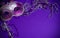 Purple Mardi-Gras or Venetian mask on purple background