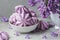 Purple meringue cookies with lilac flowers in vase on concrete background. still life. vintage toning