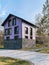 Purple modern stone and wood country house with paved path