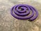 Purple mosquito coil on cement floor