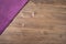 Purple napkin from left top corner wooden table