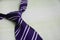 Purple necktie on wooden background. Copy space concept