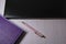 purple notepad, laptop and pink pen