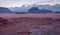 Purple orange Mars like landscape in Jordan Wadi Rum desert, mountains background, overcast morning. This location was used as set