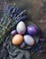 Purple painted Easter eggs with lavender on dark rustic background