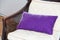 Purple pillow on wooden chair