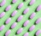 Purple pills on green background