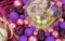 Purple, pink and golden Christmas balls on a claret velvet background