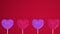 Purple pink hearts on white sticks on red isolated background. Move to the left and rotate. Copy space. Symbols of love  like