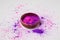 Purple and pink holi powder in bowl