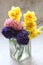 Purple and pink hyacinths and yellow daffodils, cut flowers in a vase, colorful cut flowers