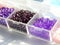 Purple, pink, lilac beads in boxes